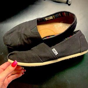 Black Toms slip ons
